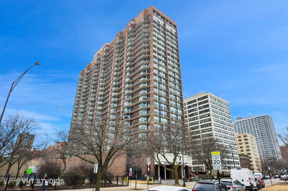 Front view of a high-rise residential building with multiple balconies.