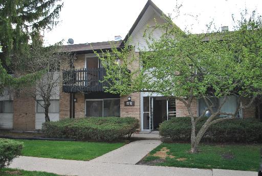 Front view of a two-story residential building with a balcony.