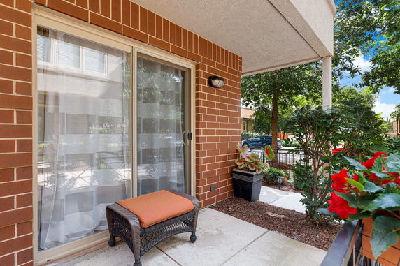 Front view of a building with a brick exterior and glass sliding door.