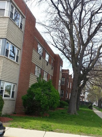 Side view of a multi-story brick apartment building.