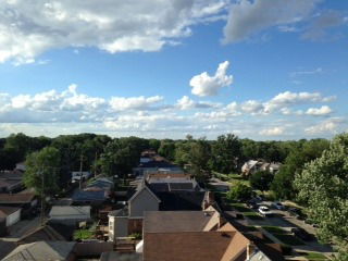 Panoramic view over a suburban neighborhood with houses and trees.