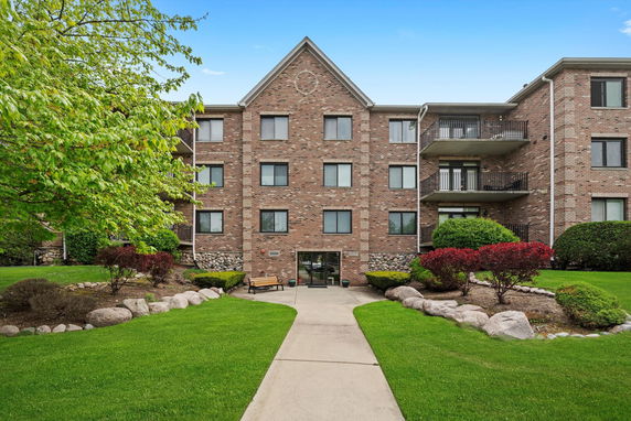 Front view of a multi-story brick apartment building.