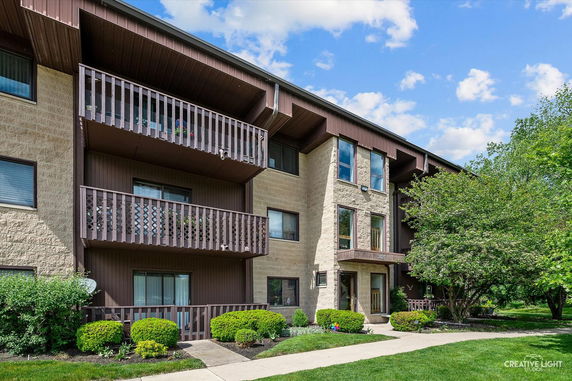 Front view of a multi-story building with balconies.
