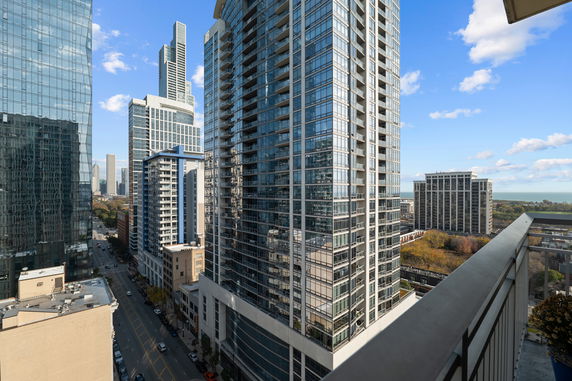 Panoramic view of multiple high-rise buildings with glass facades in an urban area.