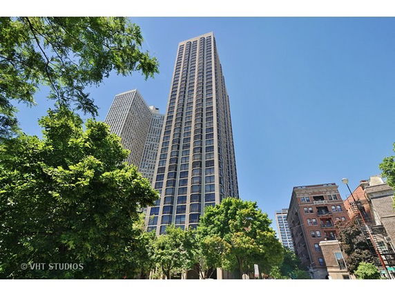 Front view of a tall skyscraper with a modern glass facade.