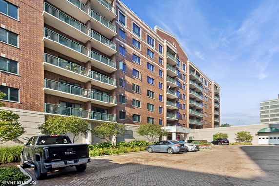 Front view of a multi-story apartment building with balconies.