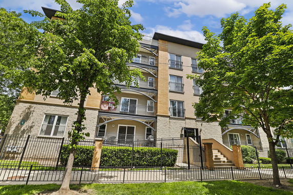 Front view of a multi-story apartment building with balconies.