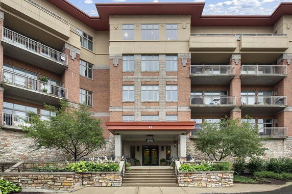 Front view of a multi-story building with balconies.