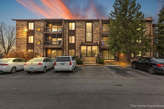 Front view of a three-story apartment building with brick facade.