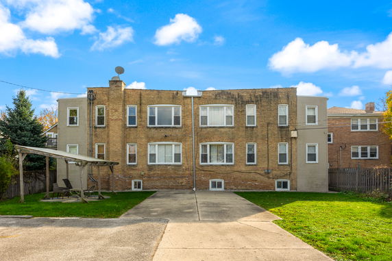 Front view of a two-story brick building with multiple windows.