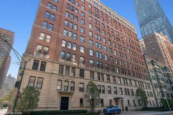 Front view of a multi-story brick building with numerous windows.