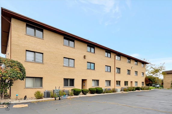 Front view of a three-story brick apartment building.