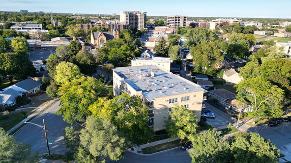 Aerial view of a residential area with trees and multiple buildings.