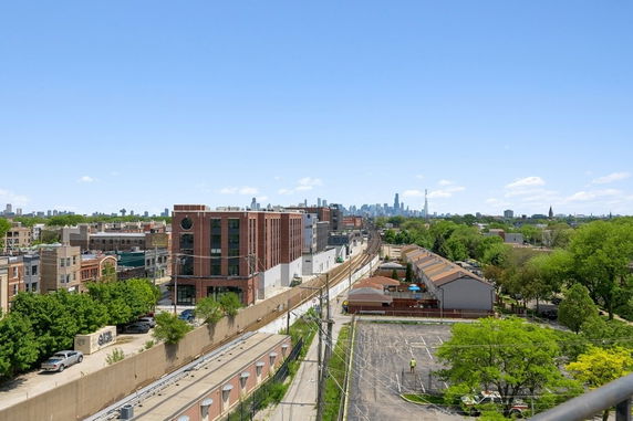 Panoramic view of urban buildings and city skyline in the distance.
