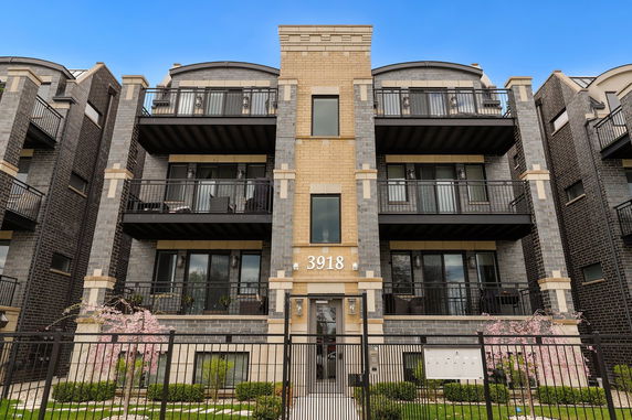 Front view of a multi-story building with balconies.