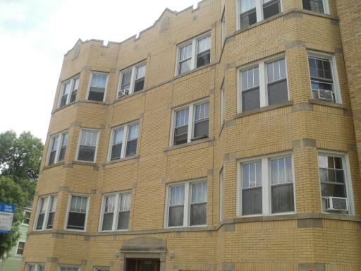 Front view of a multi-story brick apartment building.