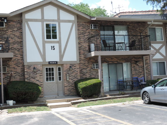 Front view of a two-story residential building with balconies.