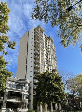Front view of a tall residential building with balconies.