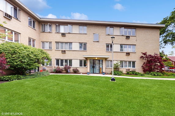 Front view of a three-story brick apartment building.