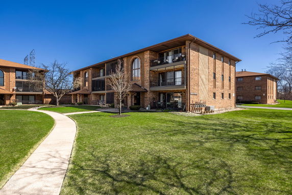 Front view of a multi-story brick apartment building.