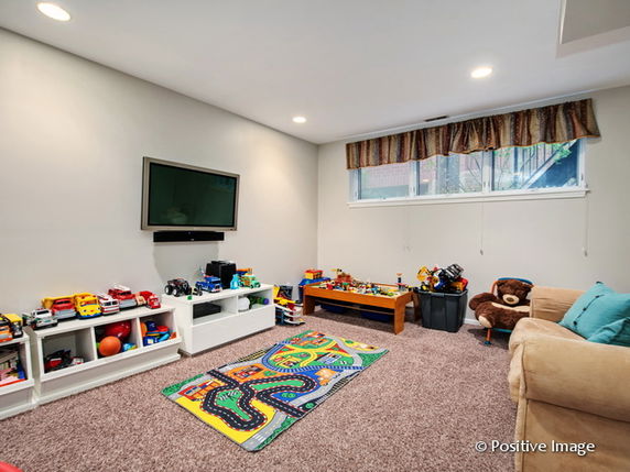 Playroom with toys, a television, and sitting area.