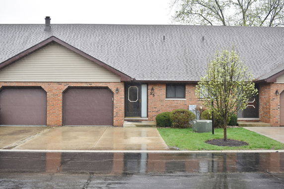 Front view of a house with a single-story design and attached garage.