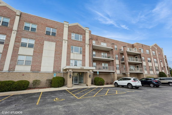 Front view of a multi-story residential building with balconies.