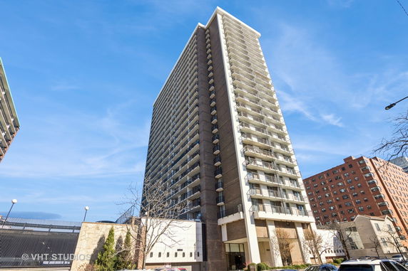 Front view of a high-rise residential building with multiple balconies.