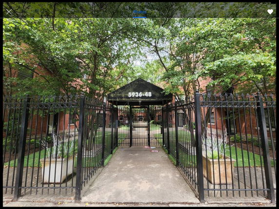 Front view of a gated entrance to a residential building complex.