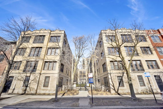 Front view of a multi-story apartment building with symmetrical design.
