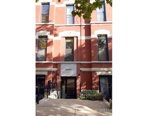 Front view of a multi-story brick building with multiple windows and a main entrance.