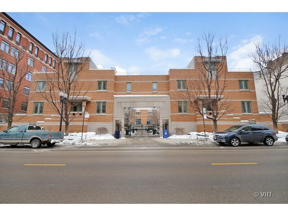 Front view of a modern brick building with symmetrical design and central archway.