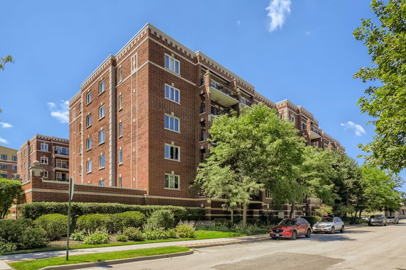 Front view of a multi-story brick apartment building.