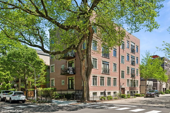 Front view of a multi-story brick apartment building.