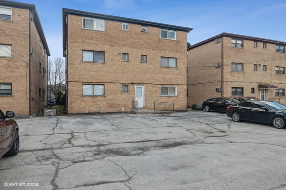 Front view of a three-story brick apartment building