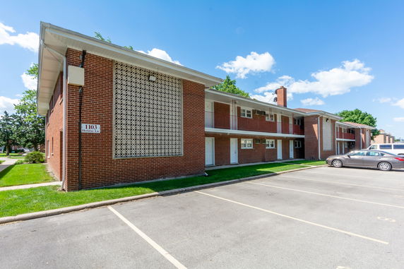 Front view of a two-story brick building with a decorative wall panel.