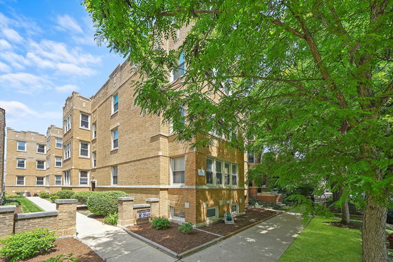 Front view of a multi-story brick apartment building.