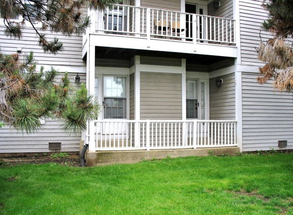 Front view of a two-story house with balconies and railing