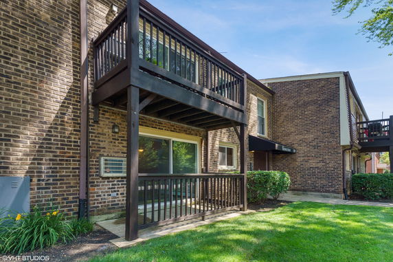 Front view of a brick building with balconies.