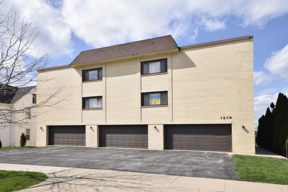 Front view of a multi-story building with multiple garage doors.