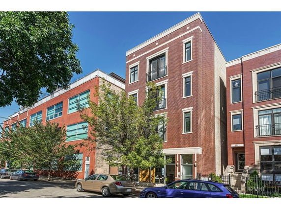 Front view of a multi-story brick building in an urban setting