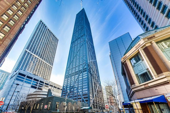 Front view of a tall skyscraper with crisscrossed exterior design.