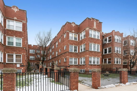 Front view of a multi-story brick apartment building.