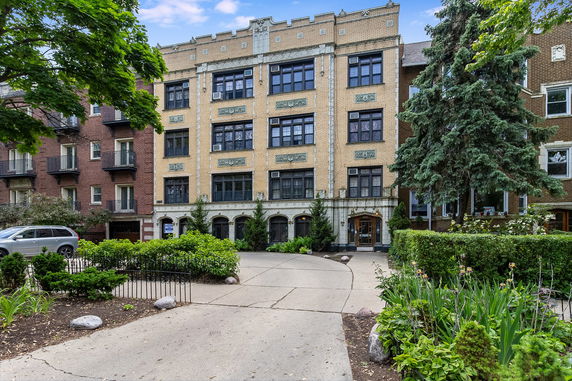 Front view of a multistory residential building with decorative facade.