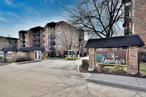 Front view of a multi-story residential building complex with brick exterior.