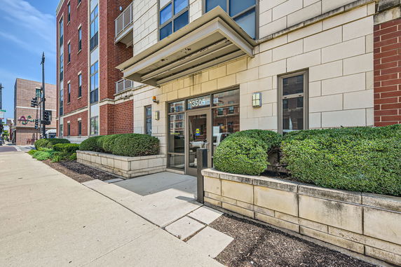 Front view of a multi-story building entrance with glass doors and number 3505.