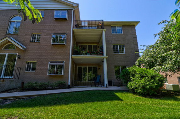 Front view of a multi-story brick building with balconies.
