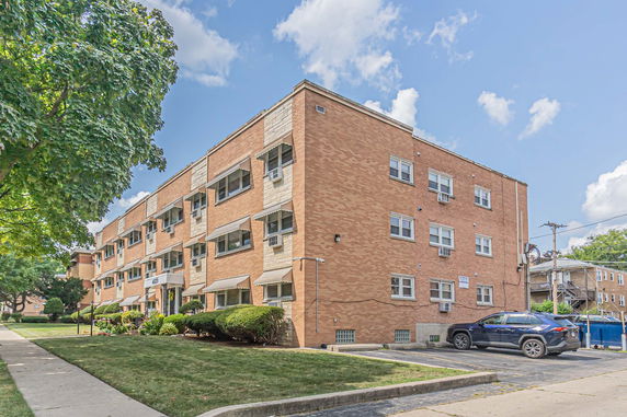 Front view of a multi-story brick apartment building.