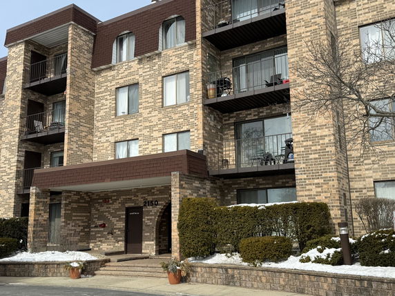 Front view of a multi-story building with balconies.