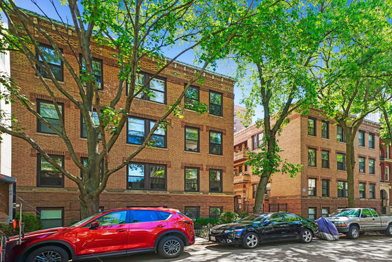 Front view of brick apartment buildings with multiple stories.